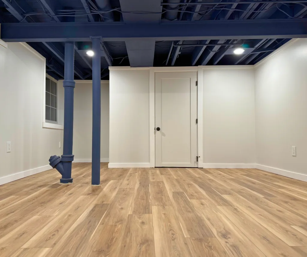 Freshly finished basement with LED lighting, painted walls, and acrylic-sealed flooring by Healthy Spaces Inc.